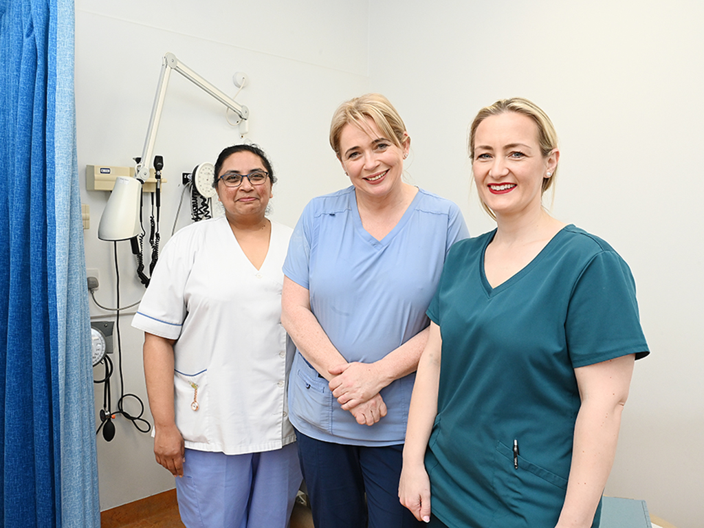 INMO members on a picket line hold INMO flags and posters
